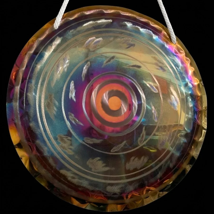 50 cm stainless steel gong with a fiery orange spiral centre and engraved leaf motifs across the surface