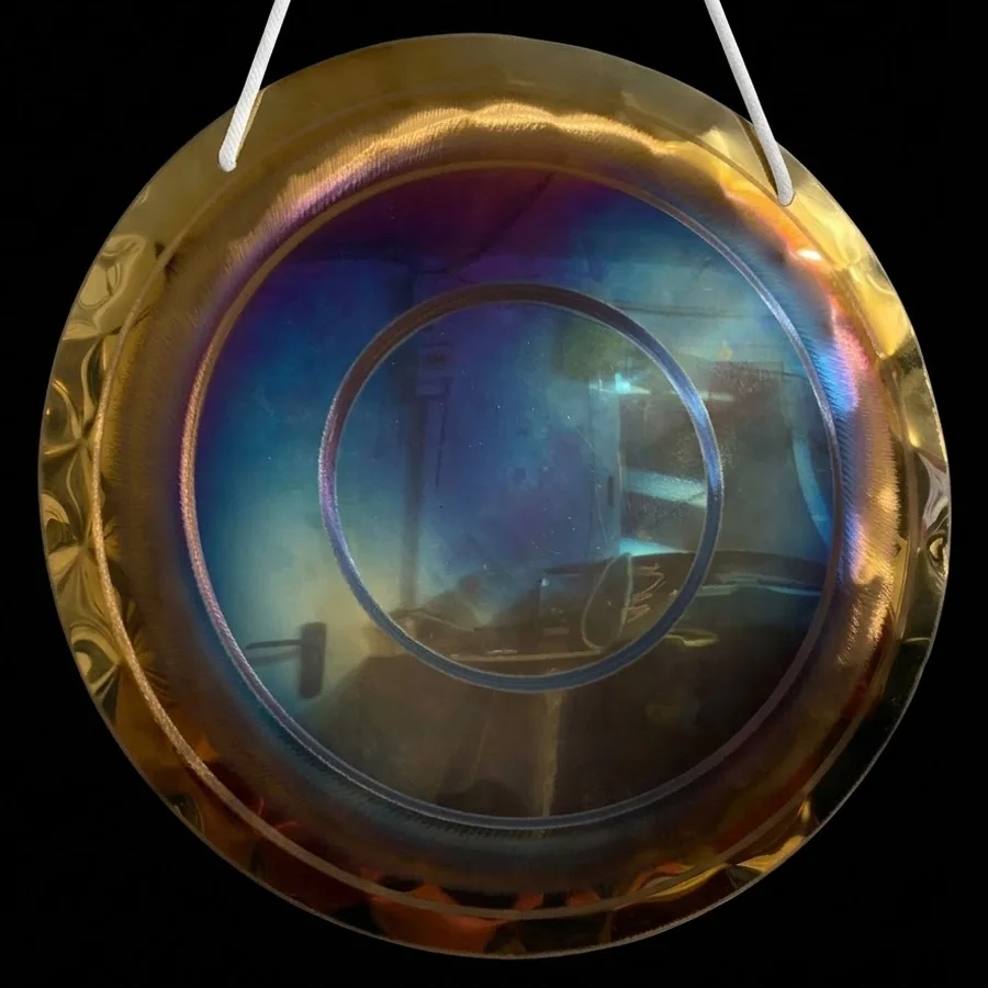 Smooth blue-tinted playing surface of a 50 cm handmade gong with two wide rings