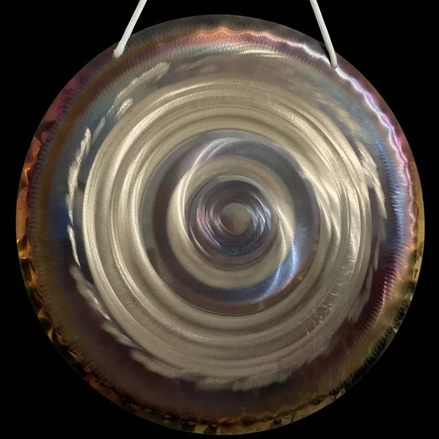 Bright silver spiral rings with a soft violet edge on a 50 cm handmade gong